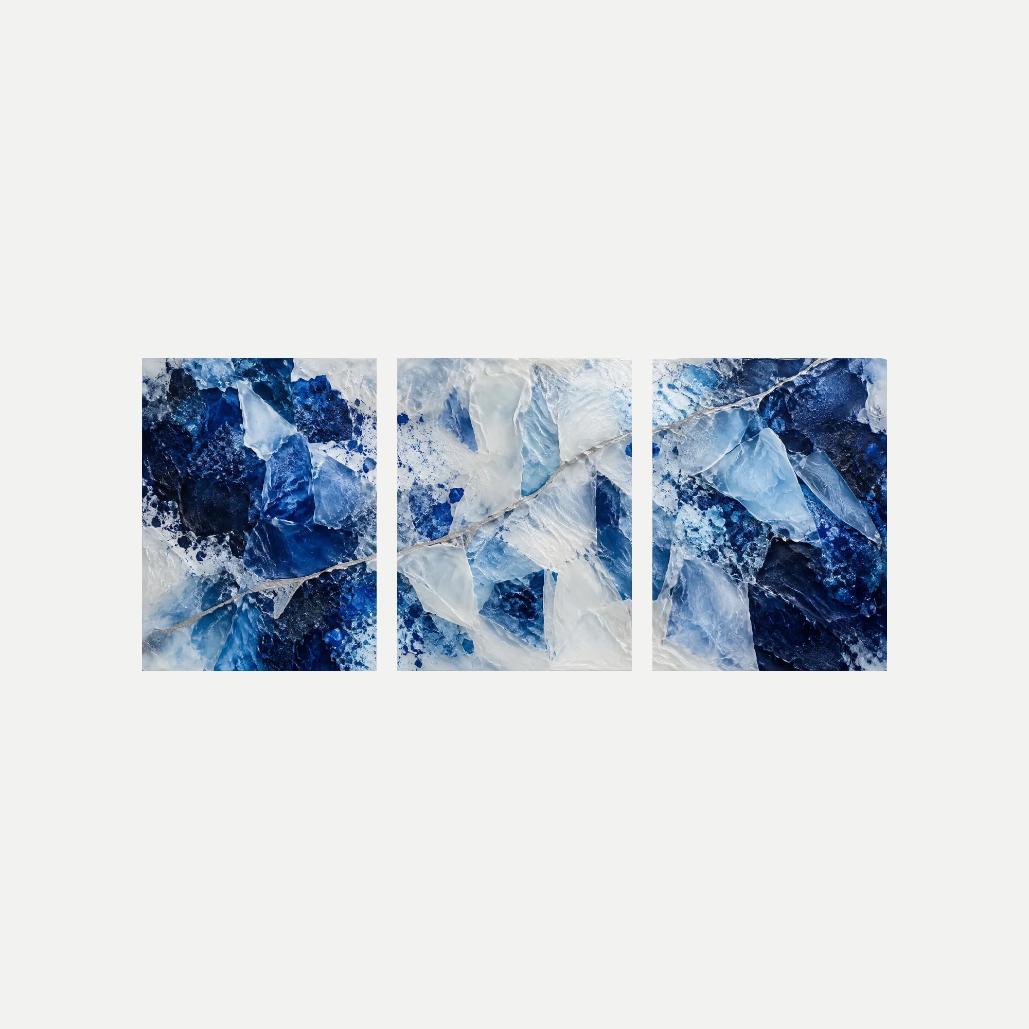 Tres paneles sin marco sobre fondo neutro con fragmentos minerales representados en azul intenso y blanco, cruzados por líneas de tono plateado.